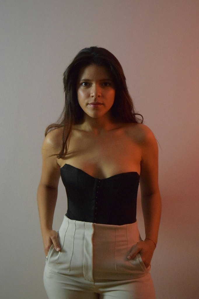 Before: Before and after AI preview of a breast augmentation made in Pody, woman in a black strapless top